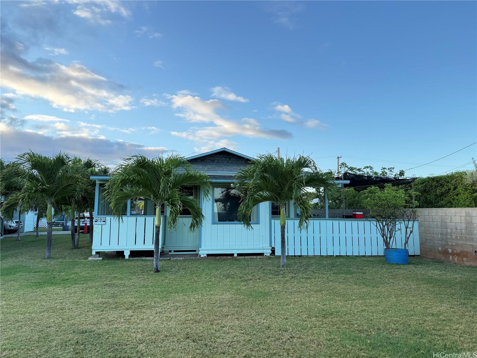 91-249 Ewa Beach Road Ewa Beach, HI 96706 - Photo 16 of 25 a backyard of a house with lots of green space and mountain view in back