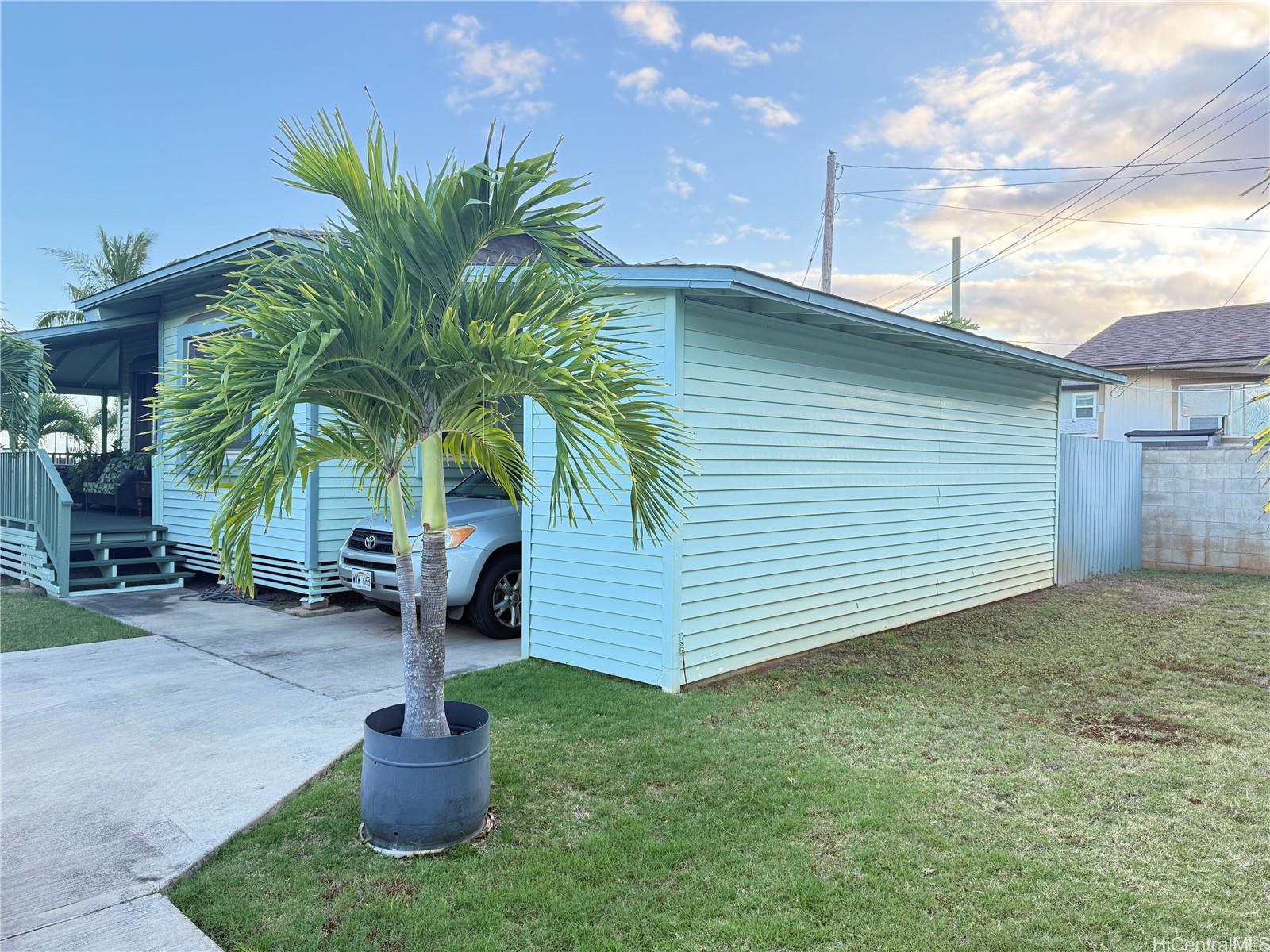 91-249 Ewa Beach Road Ewa Beach, HI 96706 - Photo 7 of 25 a house with a yard and entertaining space