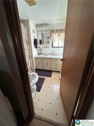 a bathroom with a sink a toilet a mirror and a tub