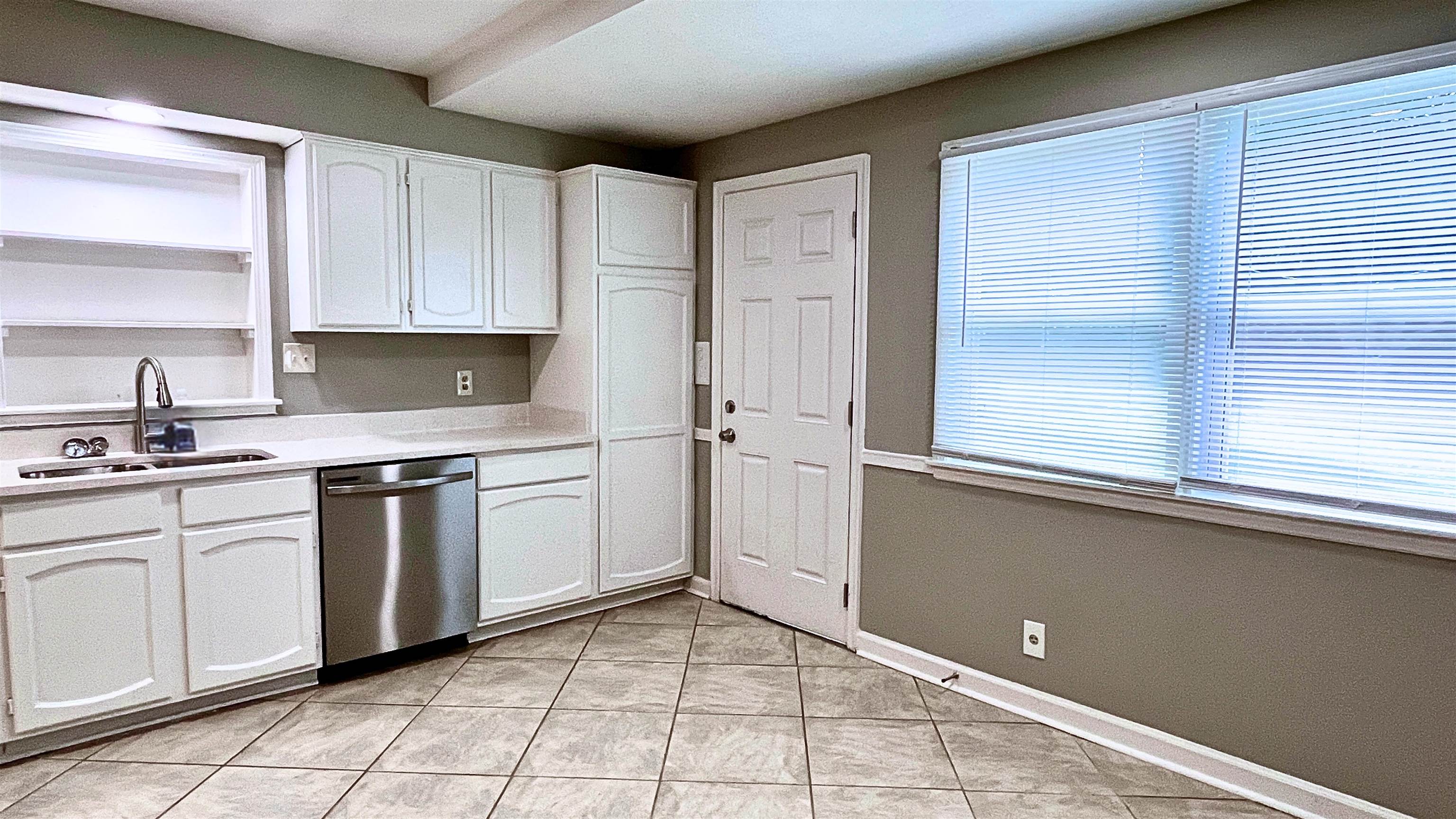 1507 Flamingo Road Memphis, TN 38117 - Photo 8 of 29 a kitchen with a stove sink and cabinets