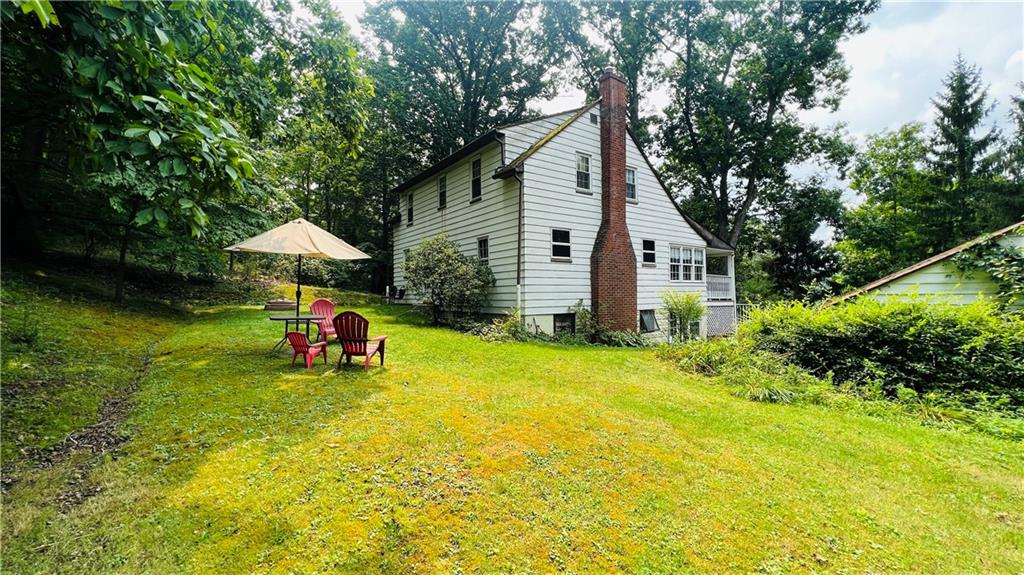 815 Pittsburgh Road Butler, PA 16002 - Photo 4 of 27 a view of a backyard with table and chairs under an umbrella