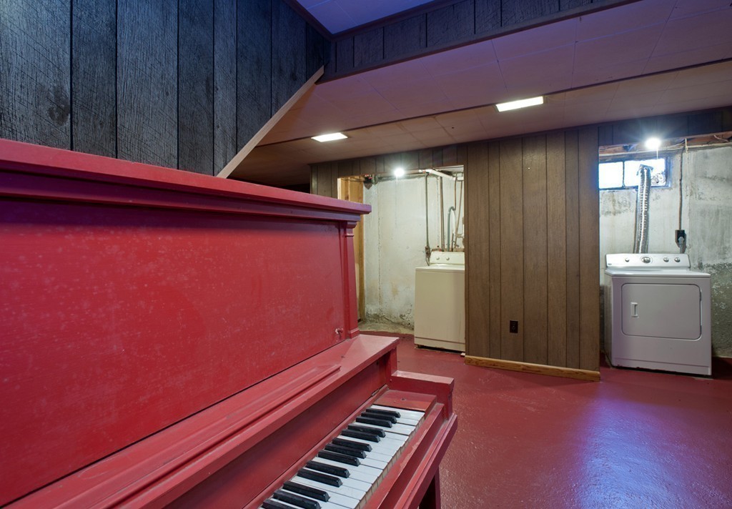 58 Franklin Road Norwell, MA 02061 - Photo 23 of 27 a view of an empty room with a piano and wooden floor