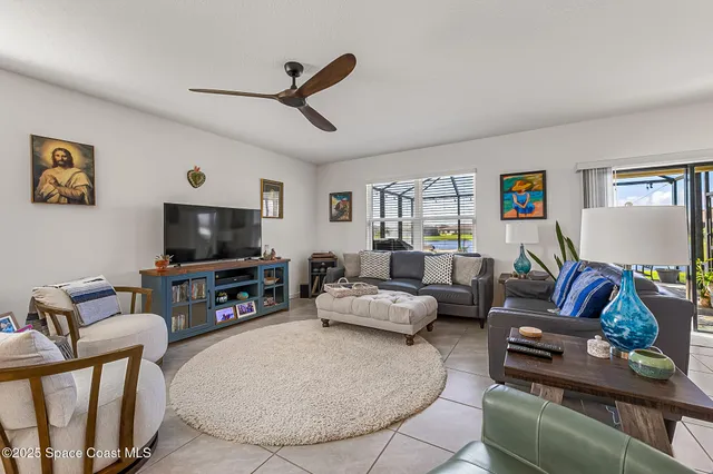 an aerial view of a pool a yard and mountain view in back
