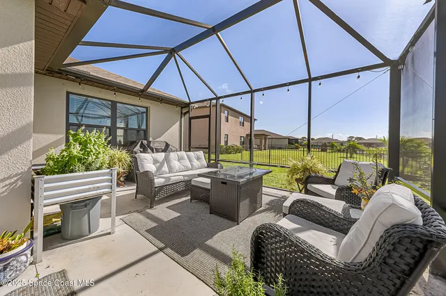 a living room with furniture a table and a flat screen tv