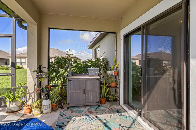 a view of a big house with a big yard and large trees