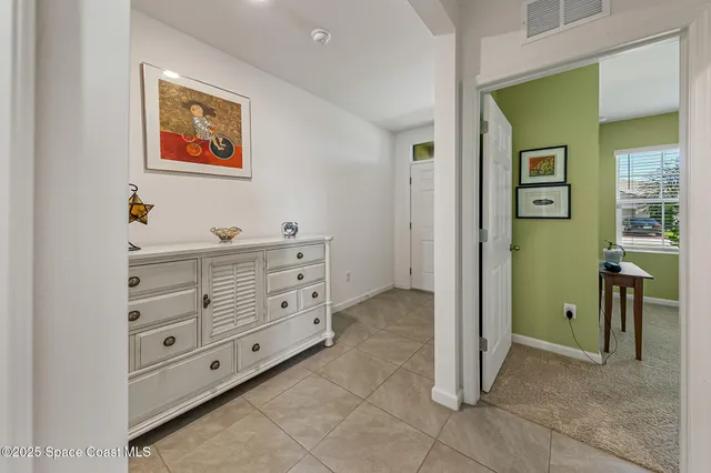 a bedroom with a bed and a lamp on dresser