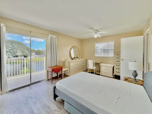 a bedroom with a bed and large window