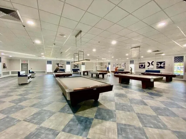 a lobby with furniture and a flat screen tv