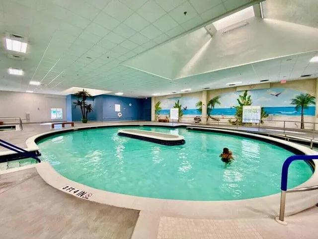 a kitchen with a sink dishwasher a stove and a microwave oven