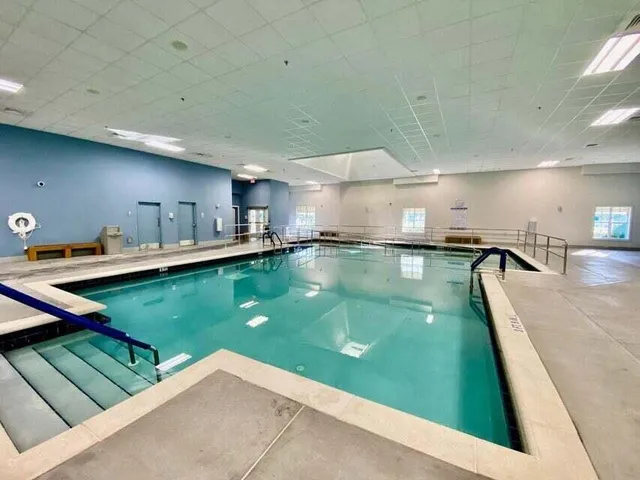 a view of a swimming pool with lawn chairs