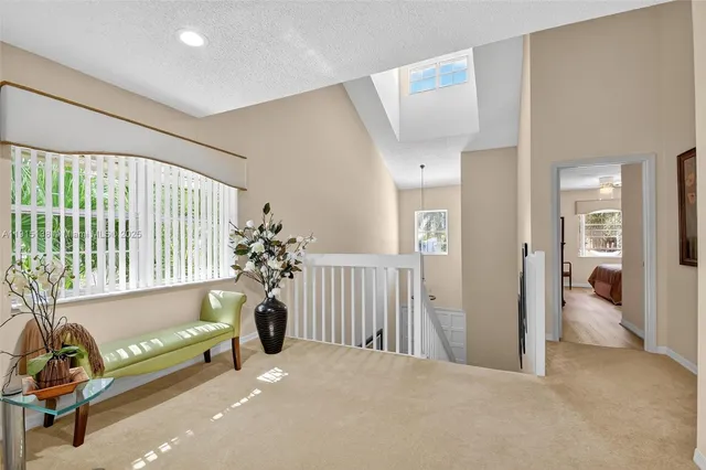 a bathroom with a granite countertop sink mirror vanity and toilet