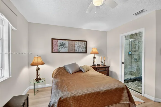 an aerial view of a house with a yard and lake view