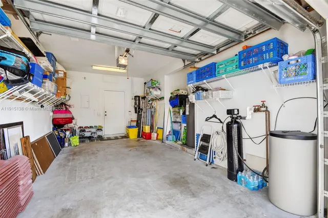 a aerial view of a house with swimming pool and large trees