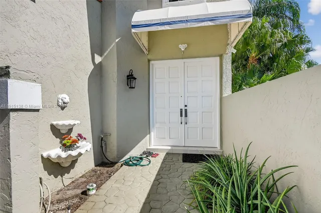 a house with potted plants in front of it