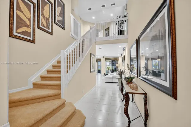 a view of an entryway with wooden floor and a livingroom