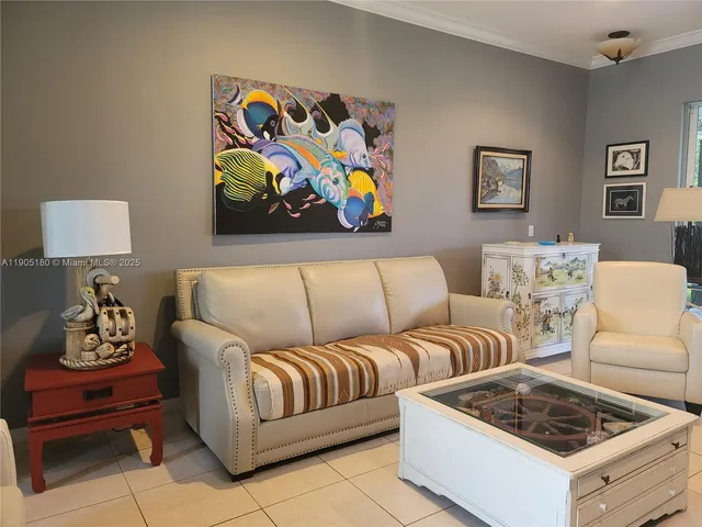 a living room with furniture and wall paintings