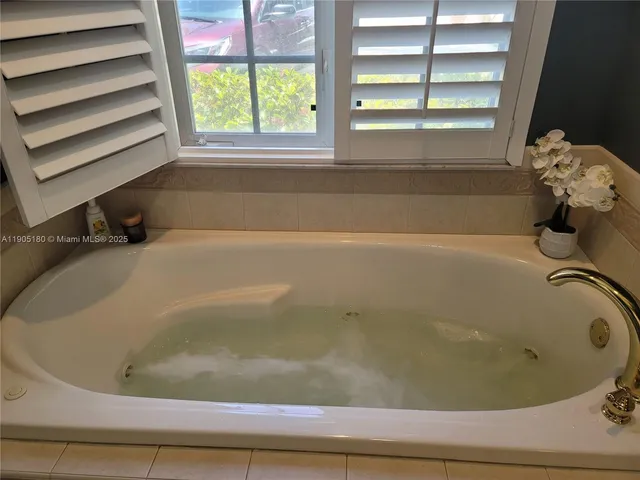a bathroom with a bathtub and a window