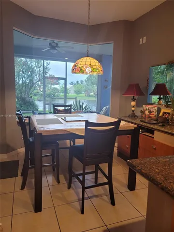 a dining room with furniture a window and outdoor view