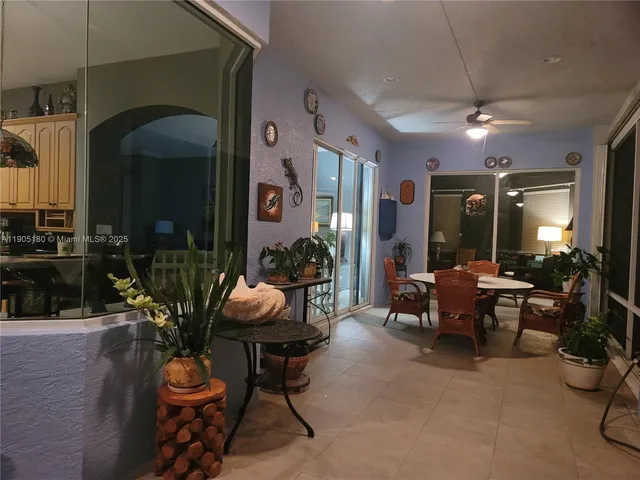 a living room with furniture and potted plants