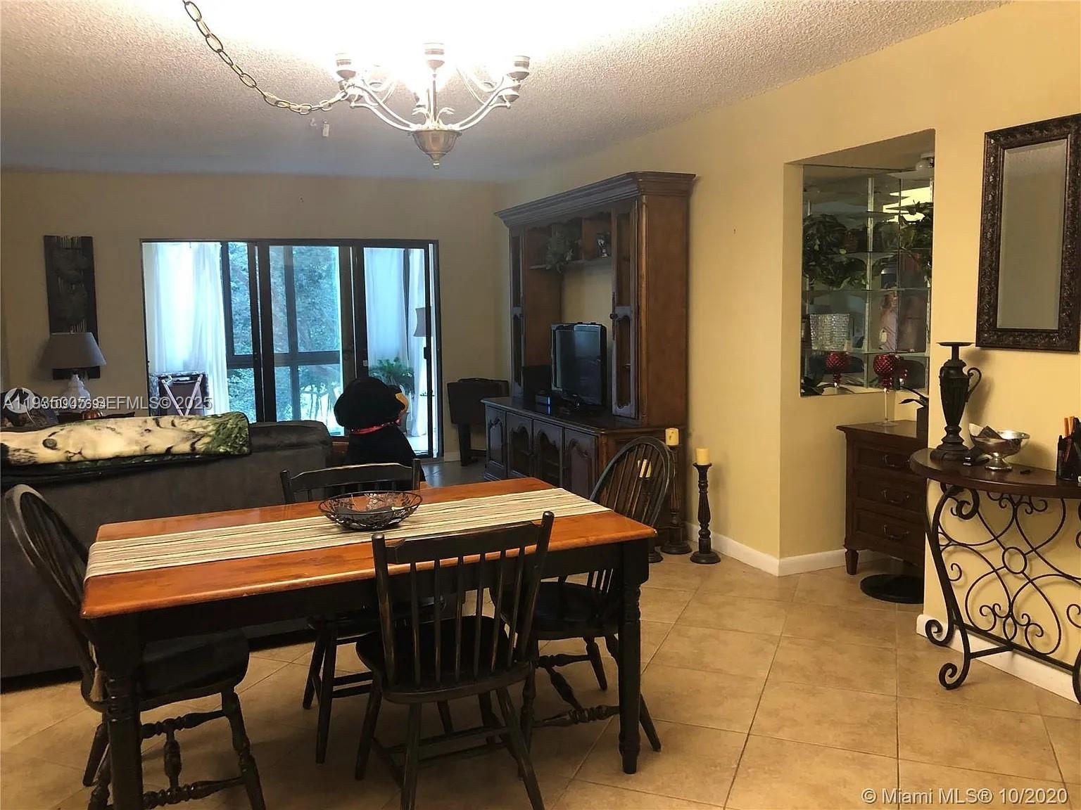 9440 Southwest 8th Street, Unit 402 Boca Raton, FL 33428 - Photo 12 of 19 a view of a dining room with furniture window and outside view