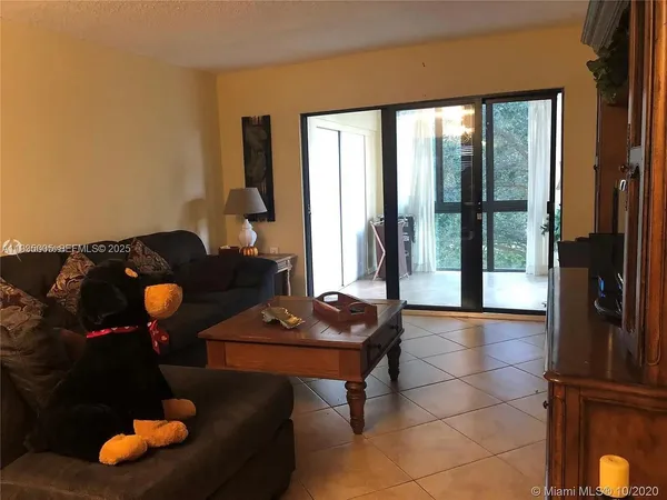 a living room with furniture and floor to ceiling window
