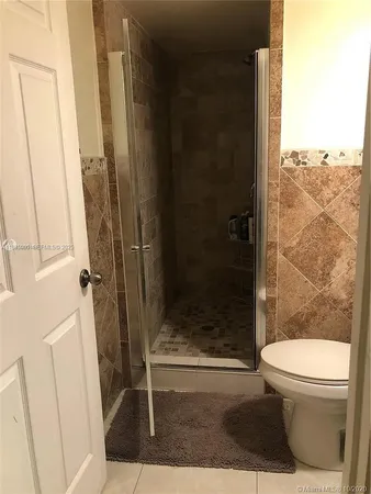 a bathroom with a shower and toilet