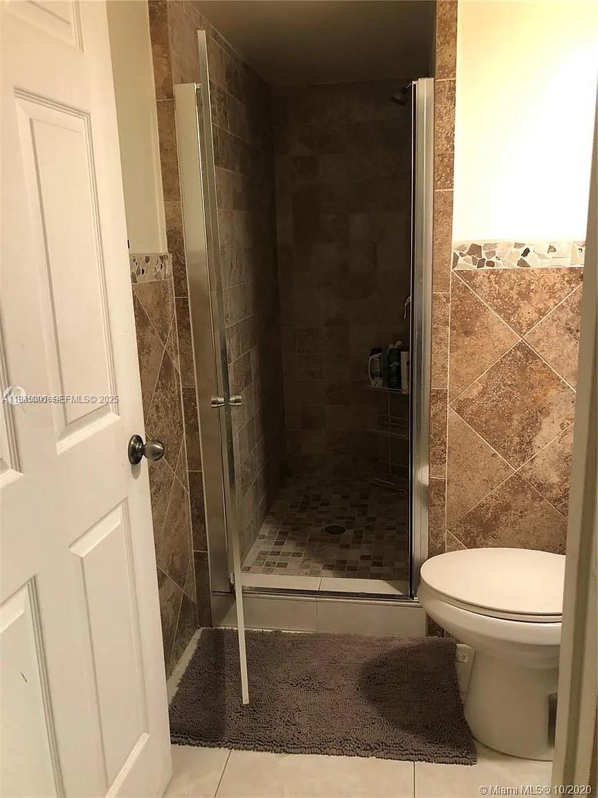 9440 Southwest 8th Street, Unit 402 Boca Raton, FL 33428 - Photo 9 of 19 a bathroom with a shower and toilet