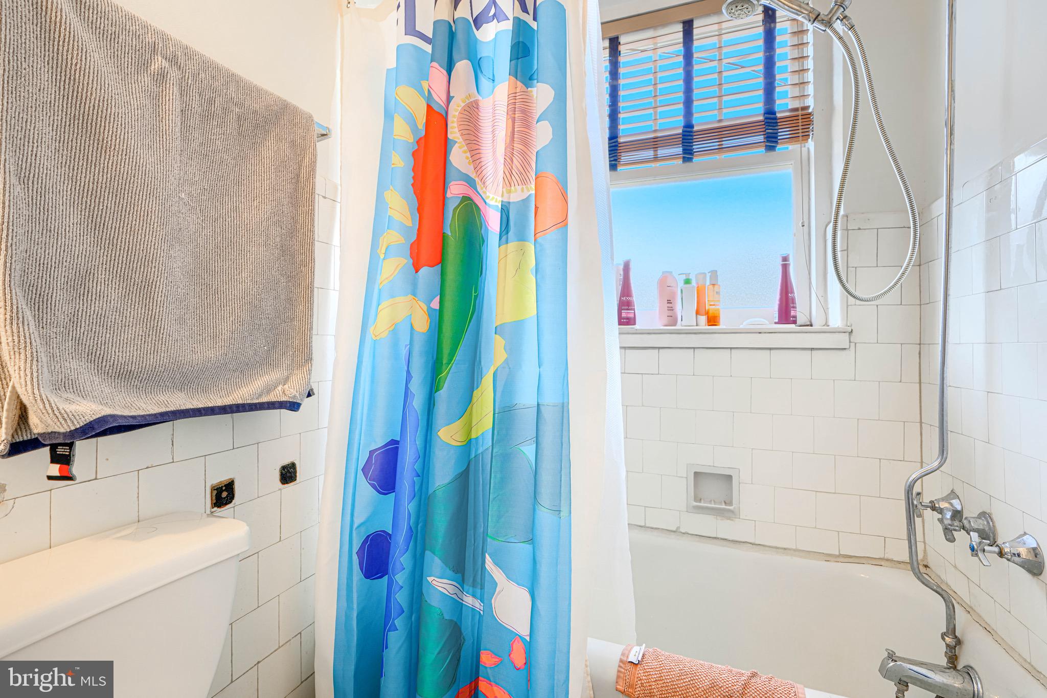607 Somerset Road, Unit 5 Baltimore, MD 21210 - Photo 35 of 38 a bathroom with a sink and a curtain