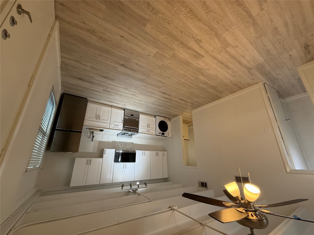 a kitchen with stainless steel appliances a refrigerator sink and microwave