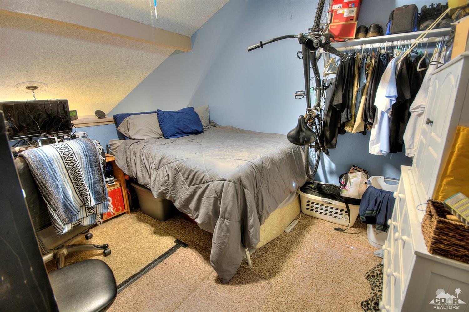 47395 Monroe Street, Unit 191 Indio, CA 92201 - Photo 17 of 21 a bed room with a bed and a chair