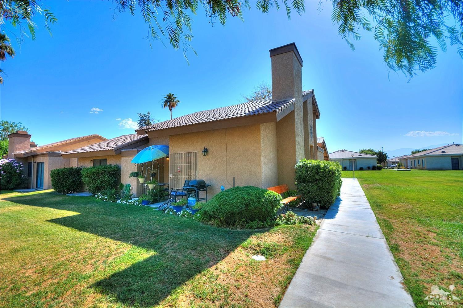 47395 Monroe Street, Unit 191 Indio, CA 92201 - Photo 19 of 21 a front view of a house with garden