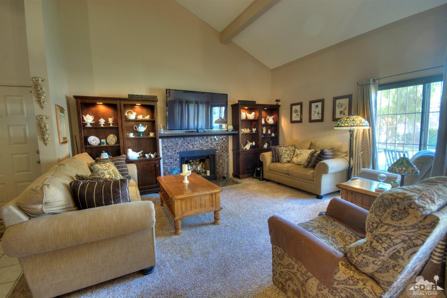47395 Monroe Street, Unit 191 Indio, CA 92201 - Photo 3 of 21 a living room with fireplace furniture and a large window