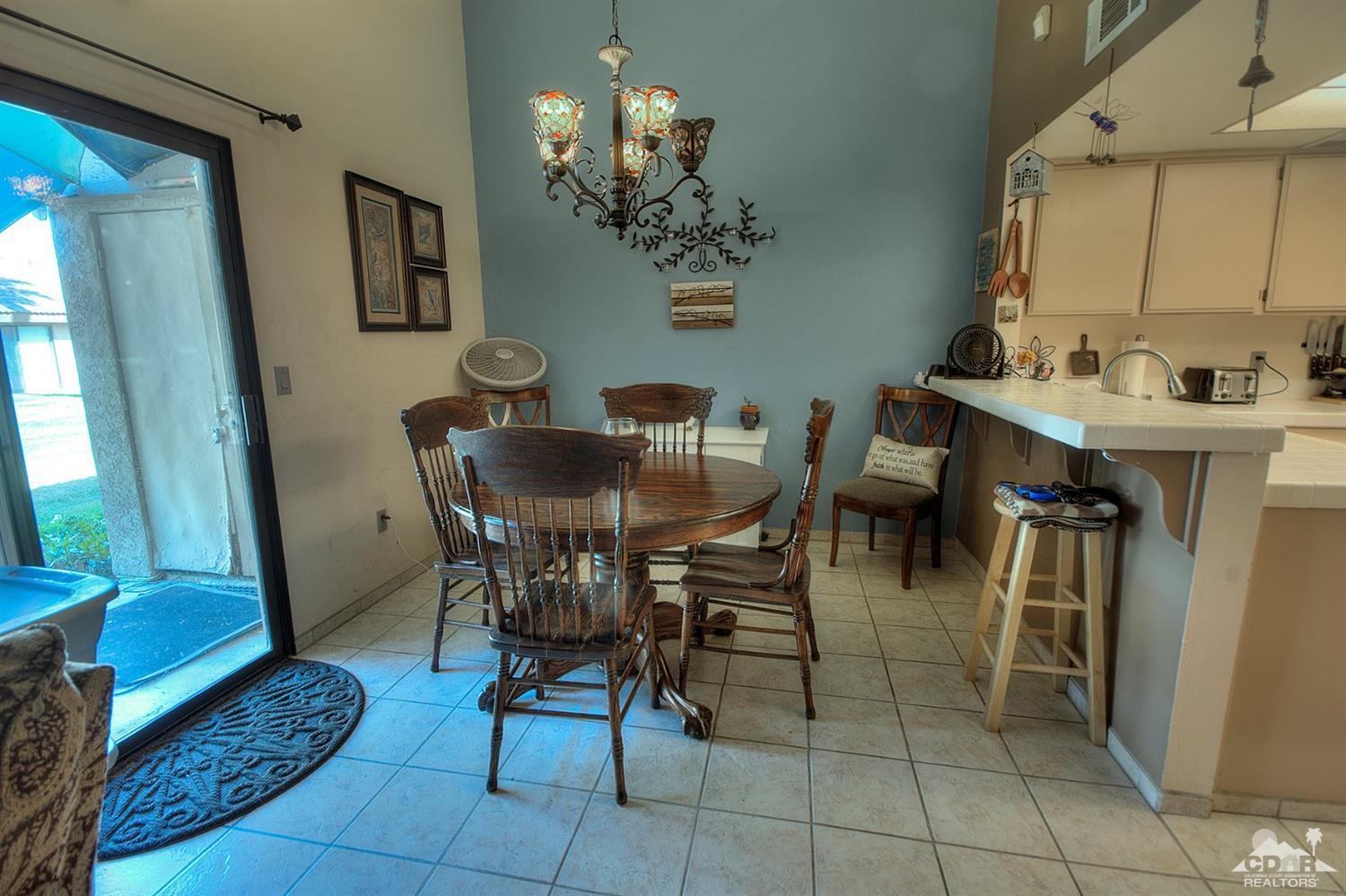 47395 Monroe Street, Unit 191 Indio, CA 92201 - Photo 7 of 21 a view of a dining room with furniture and a chandelier