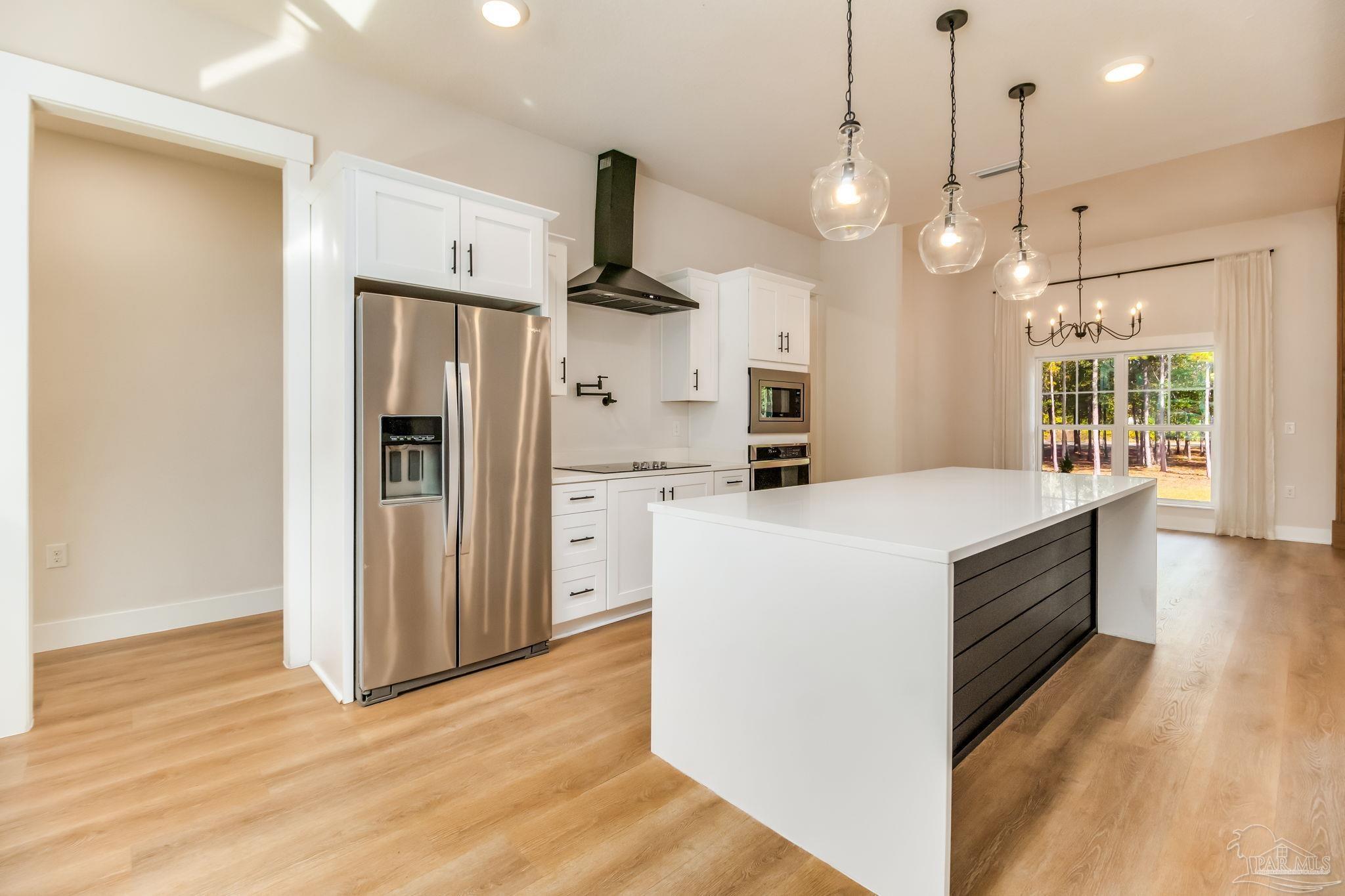 2329 Molino Bridge Road Pace, FL 32571 - Photo 12 of 65 a kitchen with a refrigerator a sink and wooden floor