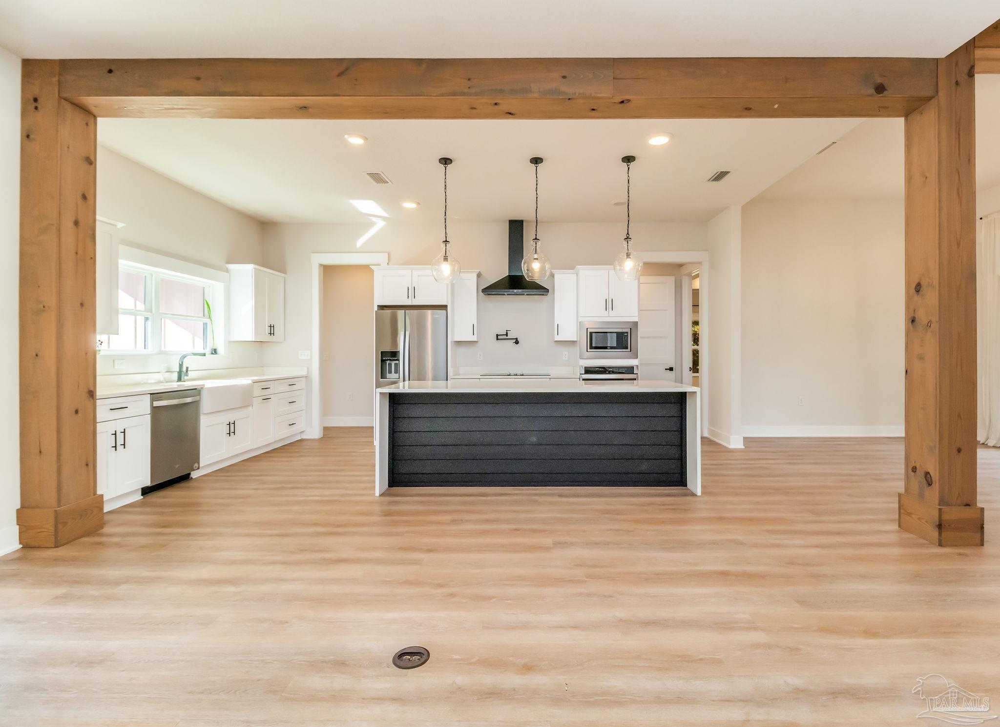 2329 Molino Bridge Road Pace, FL 32571 - Photo 15 of 65 a large white kitchen with kitchen island a sink a stove and white cabinets