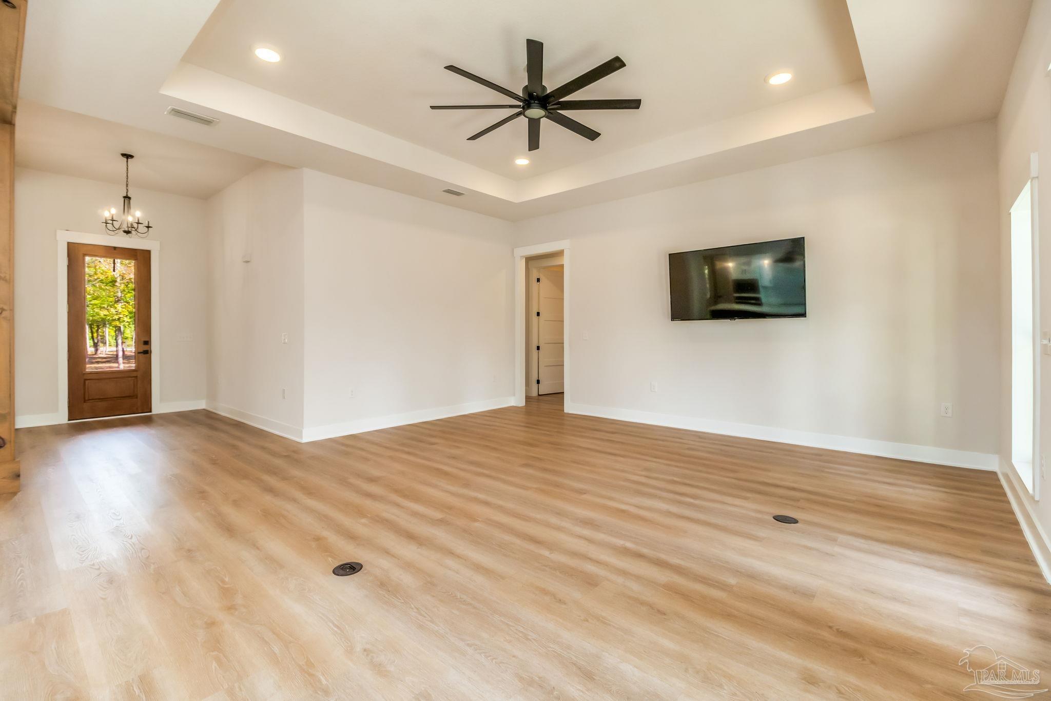 2329 Molino Bridge Road Pace, FL 32571 - Photo 21 of 65 a view of a livingroom with a flat screen tv and wooden floor