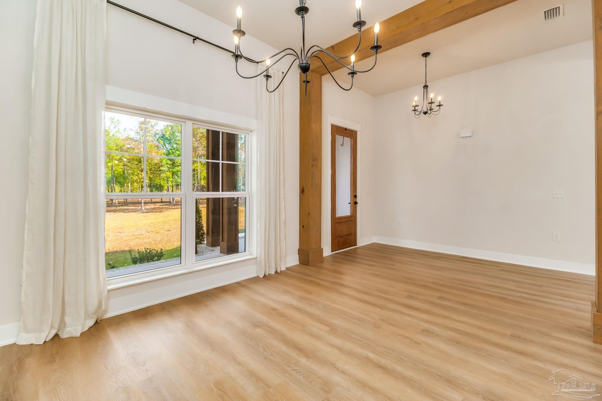 2329 Molino Bridge Road Pace, FL 32571 - Photo 22 of 65 a view of an empty room with a window and wooden floor
