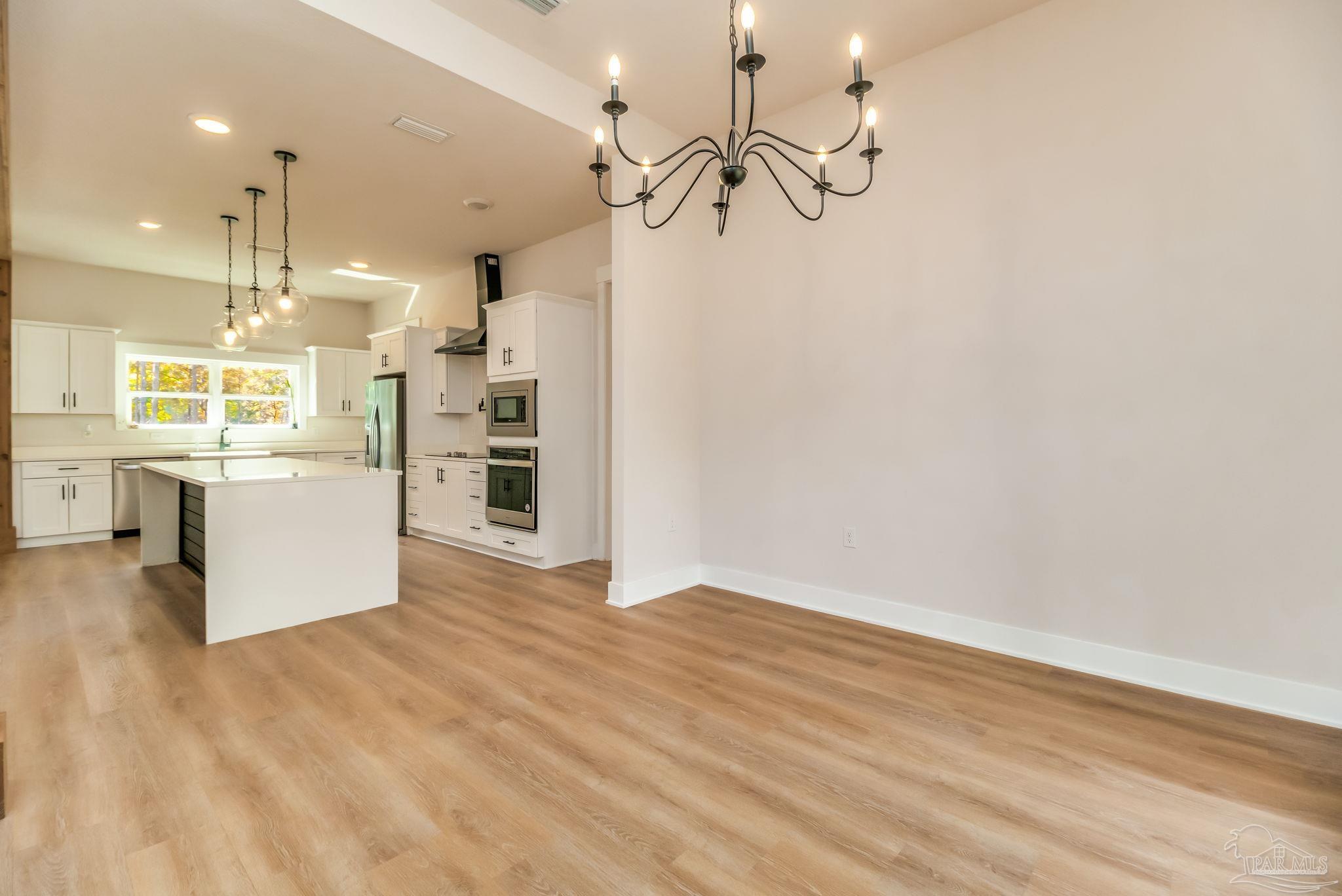 2329 Molino Bridge Road Pace, FL 32571 - Photo 25 of 65 a view of a kitchen with a white cabinet and stainless steel appliances