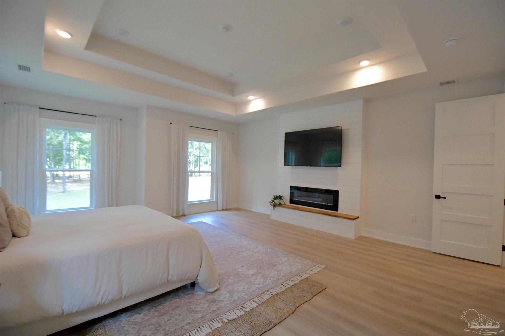 2329 Molino Bridge Road Pace, FL 32571 - Photo 29 of 65 a spacious bedroom with a bed and a flat screen tv