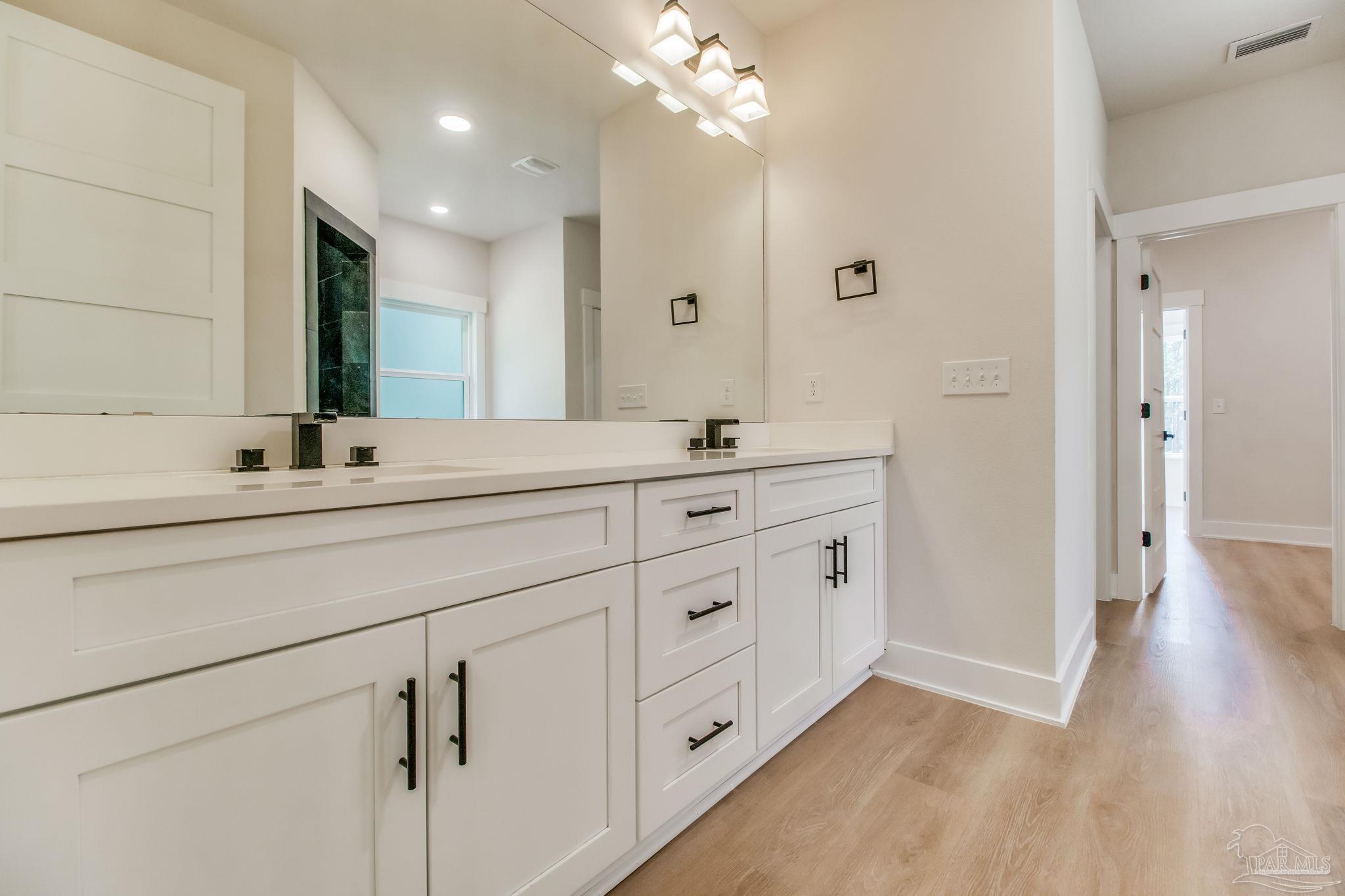 2329 Molino Bridge Road Pace, FL 32571 - Photo 30 of 65 a bathroom with a double vanity sink and a mirror