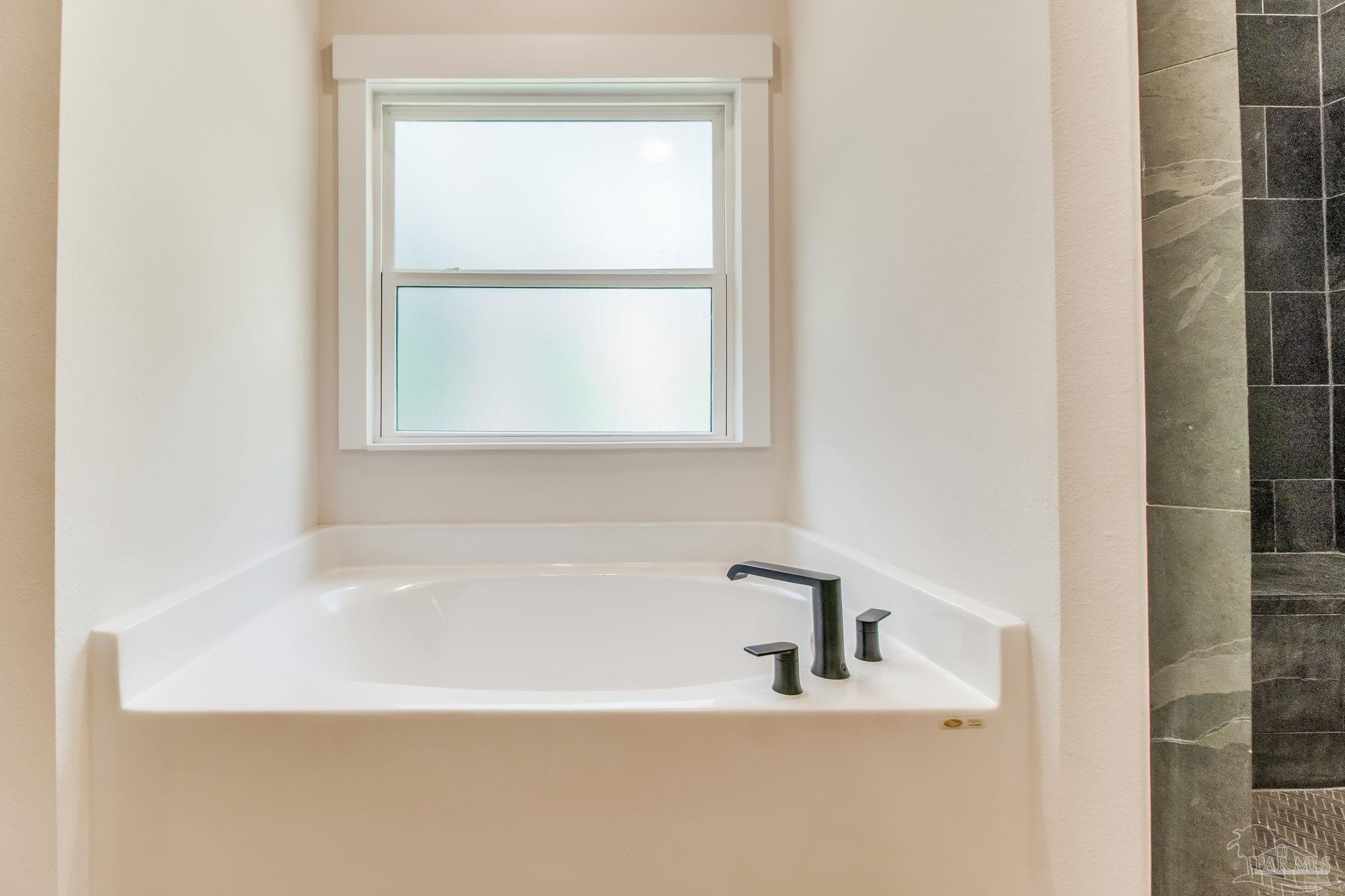 2329 Molino Bridge Road Pace, FL 32571 - Photo 33 of 65 a white bath tub sitting next to a window