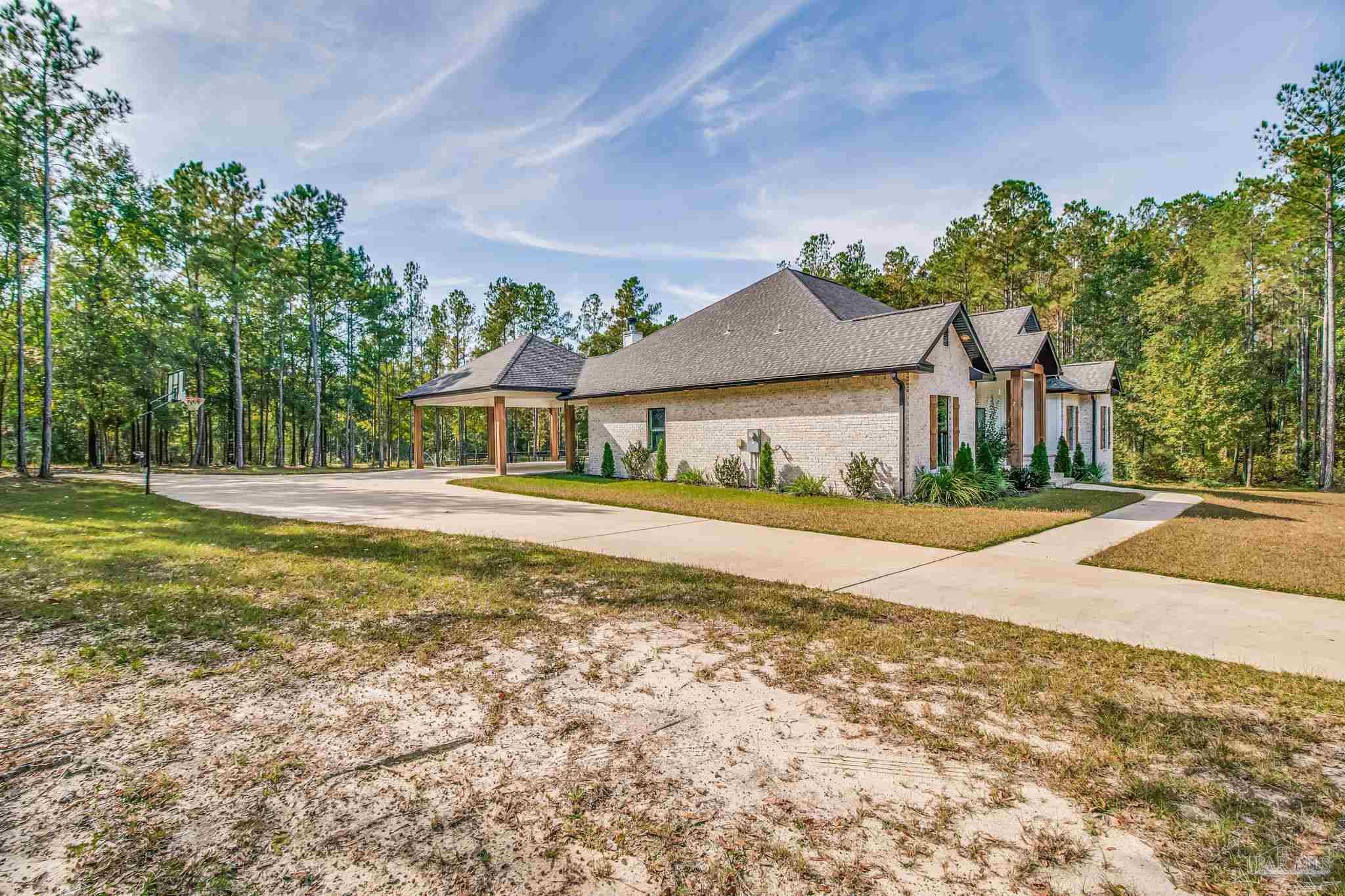 2329 Molino Bridge Road Pace, FL 32571 - Photo 45 of 65 a house with garden in front of it