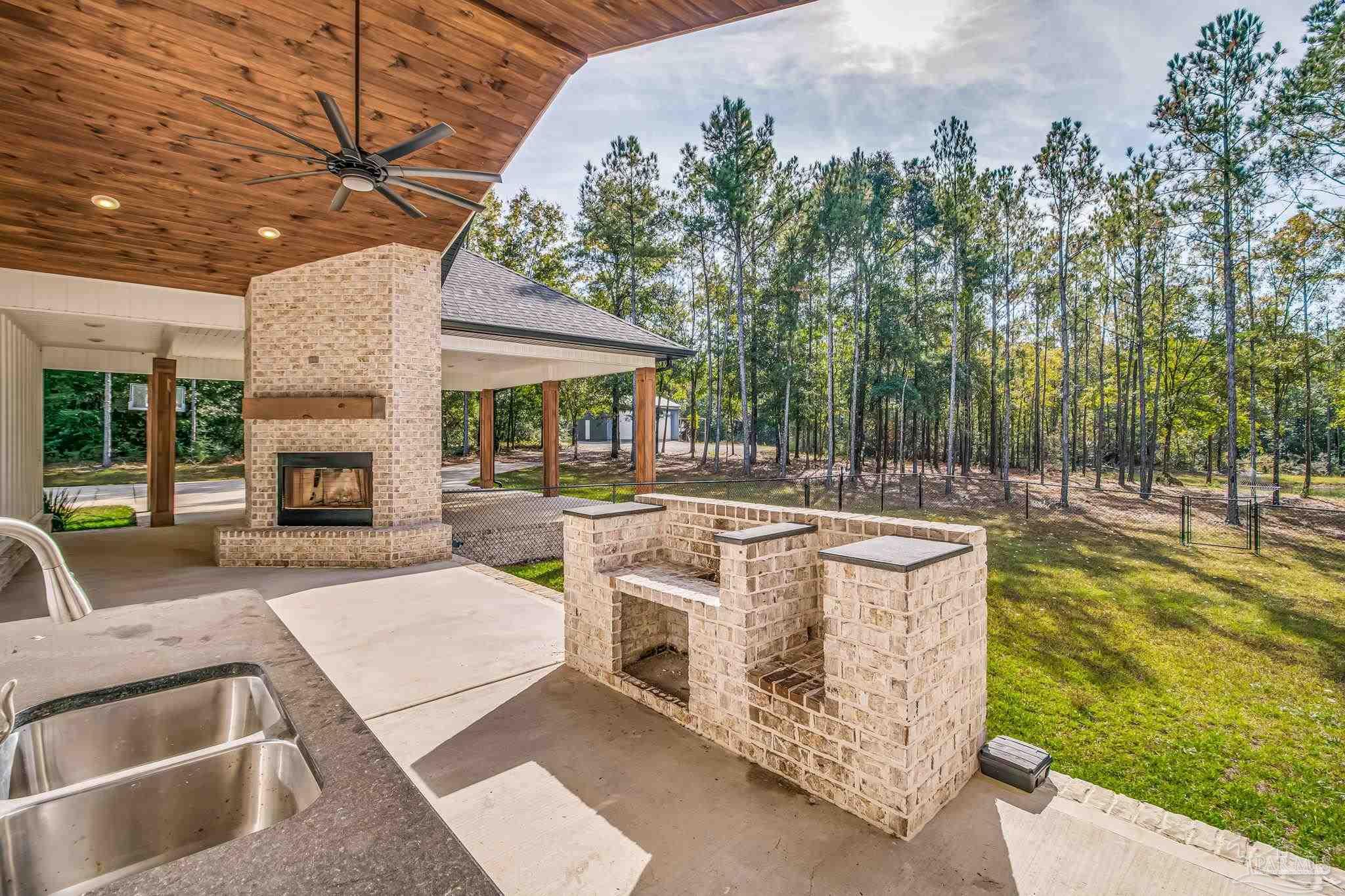 2329 Molino Bridge Road Pace, FL 32571 - Photo 50 of 65 a view of a swimming pool with outdoor seating and plants