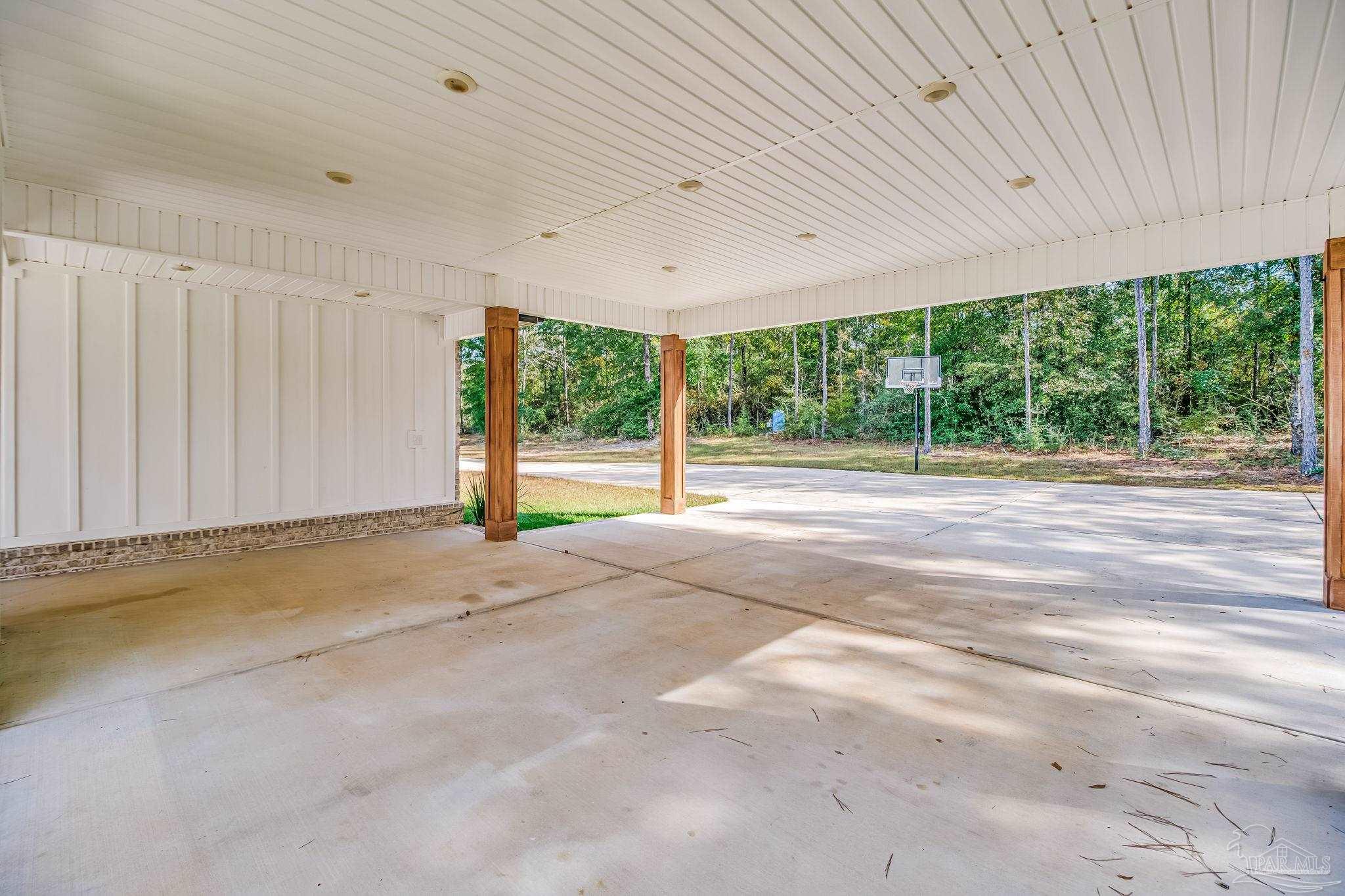 2329 Molino Bridge Road Pace, FL 32571 - Photo 51 of 65 a view of a room with large windows and a ceiling fan