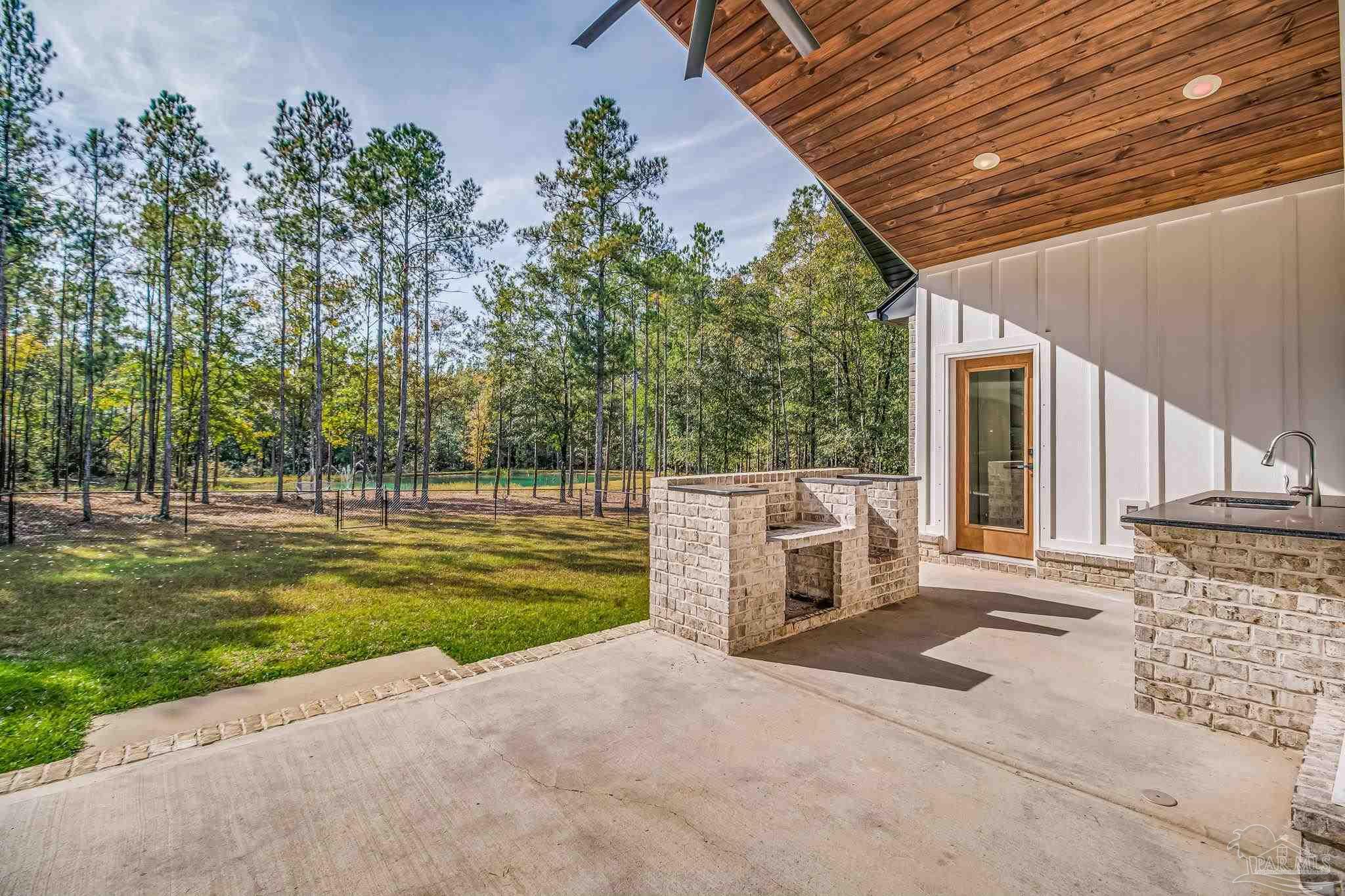 2329 Molino Bridge Road Pace, FL 32571 - Photo 52 of 65 a view of a backyard with garden and plants