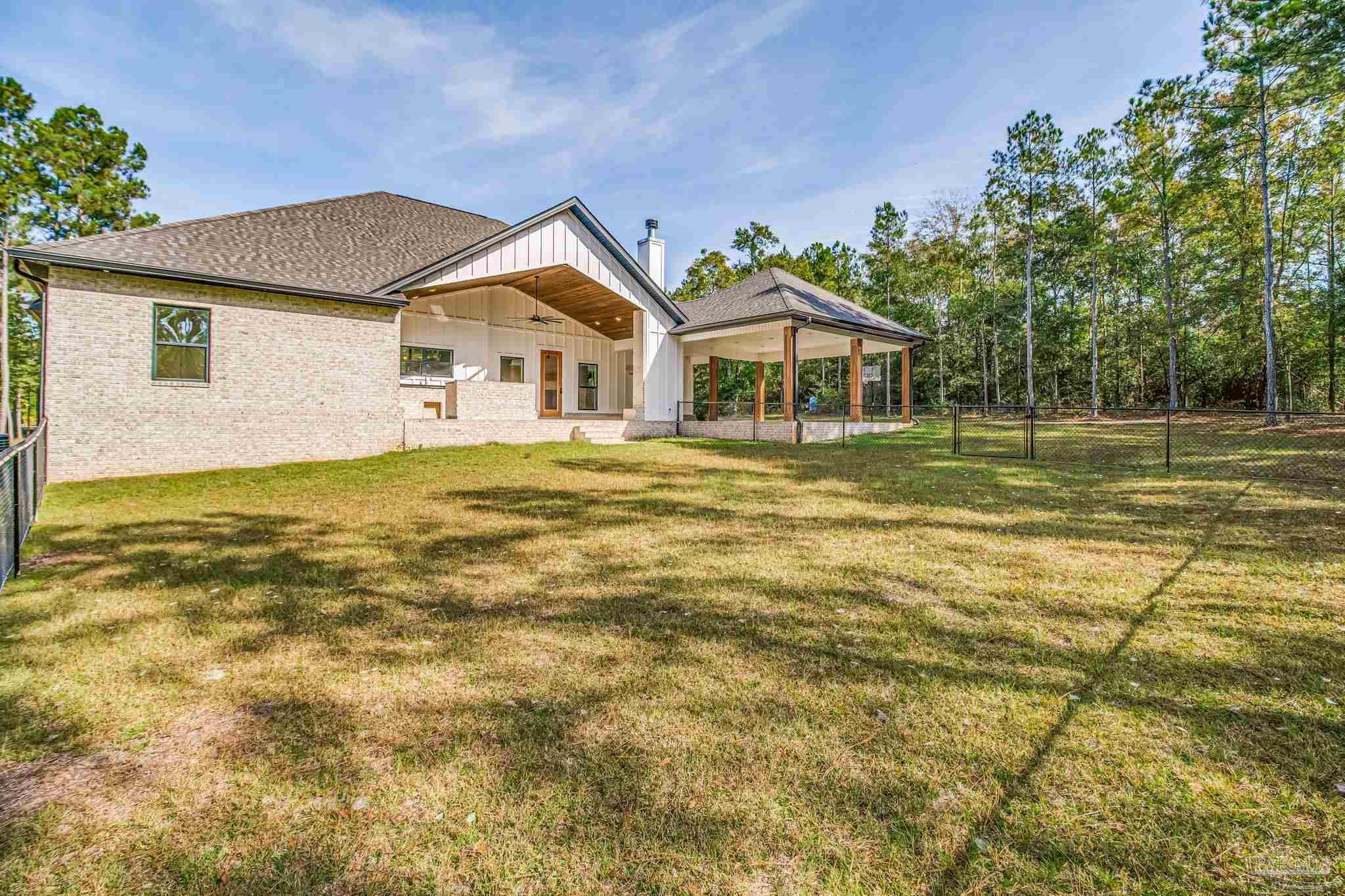 2329 Molino Bridge Road Pace, FL 32571 - Photo 55 of 65 a front view of a house with a yard