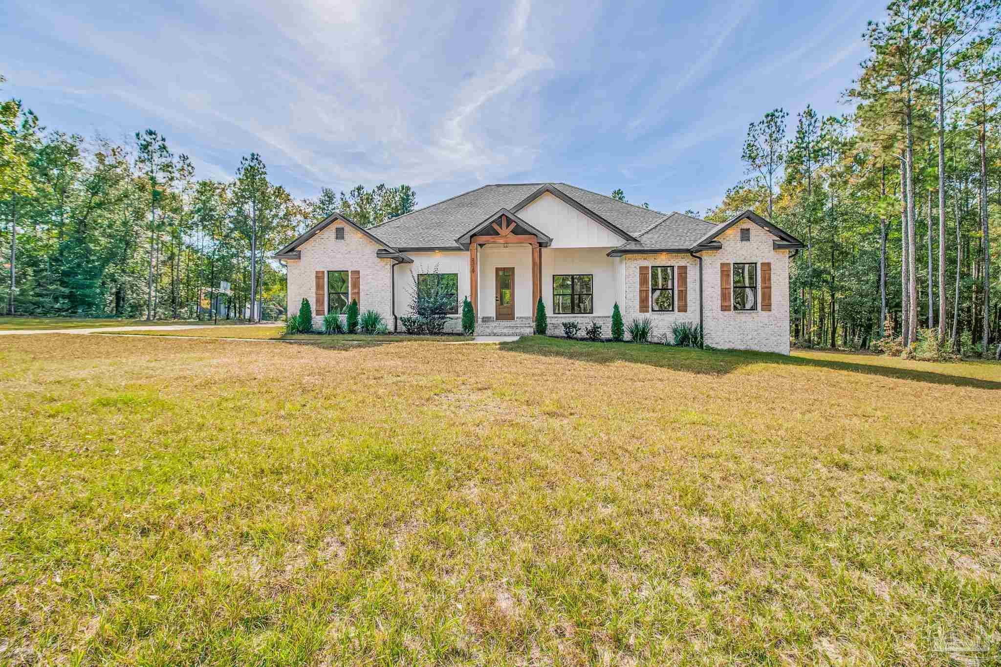 2329 Molino Bridge Road Pace, FL 32571 - Photo 7 of 65 a front view of a house with a yard