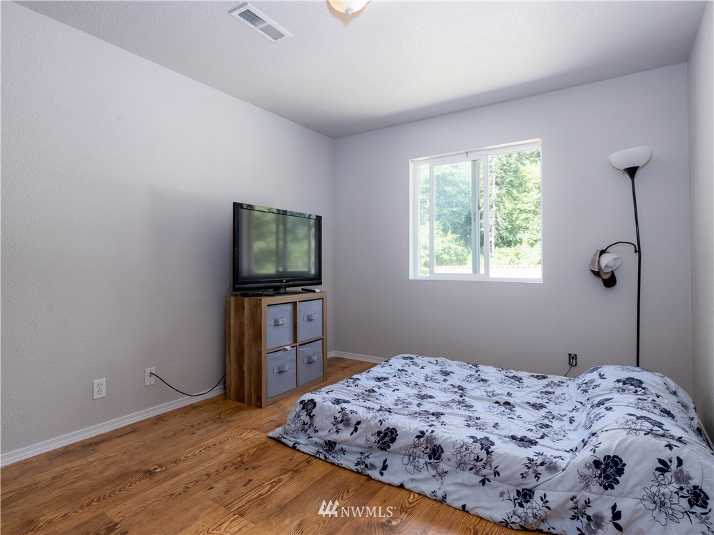 553 River Road Chehalis, WA 98532 - Photo 11 of 22 a bedroom with a bed and a flat screen tv