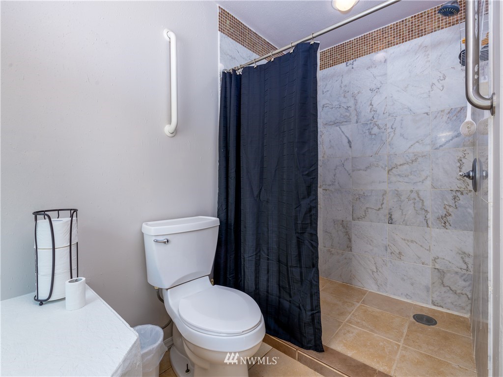 553 River Road Chehalis, WA 98532 - Photo 13 of 22 a white toilet sitting next to a shower