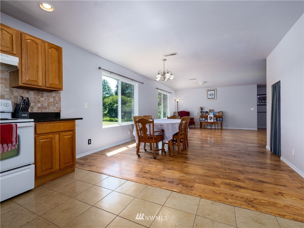 553 River Road Chehalis, WA 98532 - Photo 5 of 22 a dining room with chandelier stainless steel appliances a dining table and chairs
